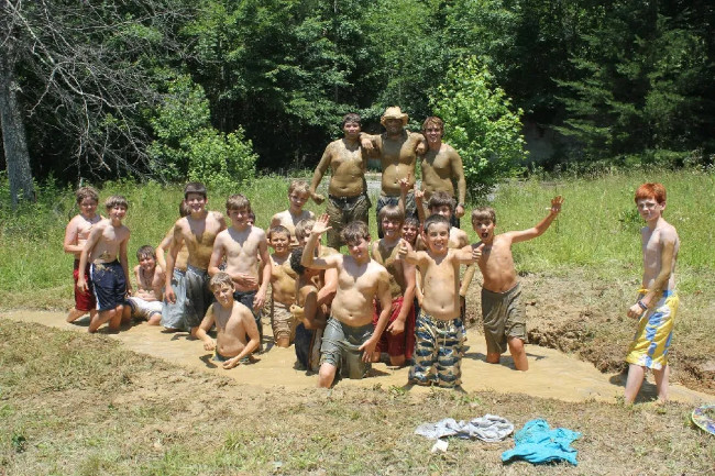 Group-of-boys-gathered-for-a-photo-while-having-fun-in-mud